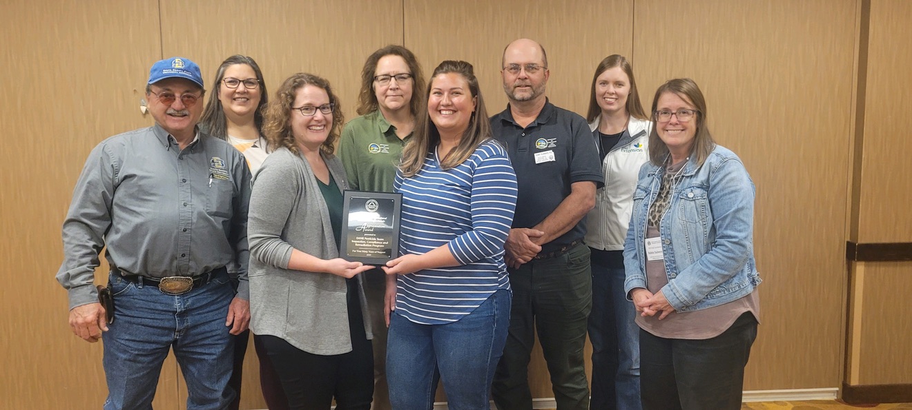 The South Dakota Association of Agricultural Extension Professionals present the Friend of the SDAAEP Award to the SD DANR Inspection, Compliance and Remediation employees