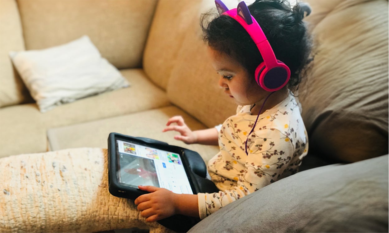 Young child using a tablet.