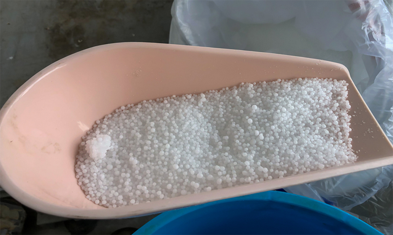 Urea supplement in a feed scoop.