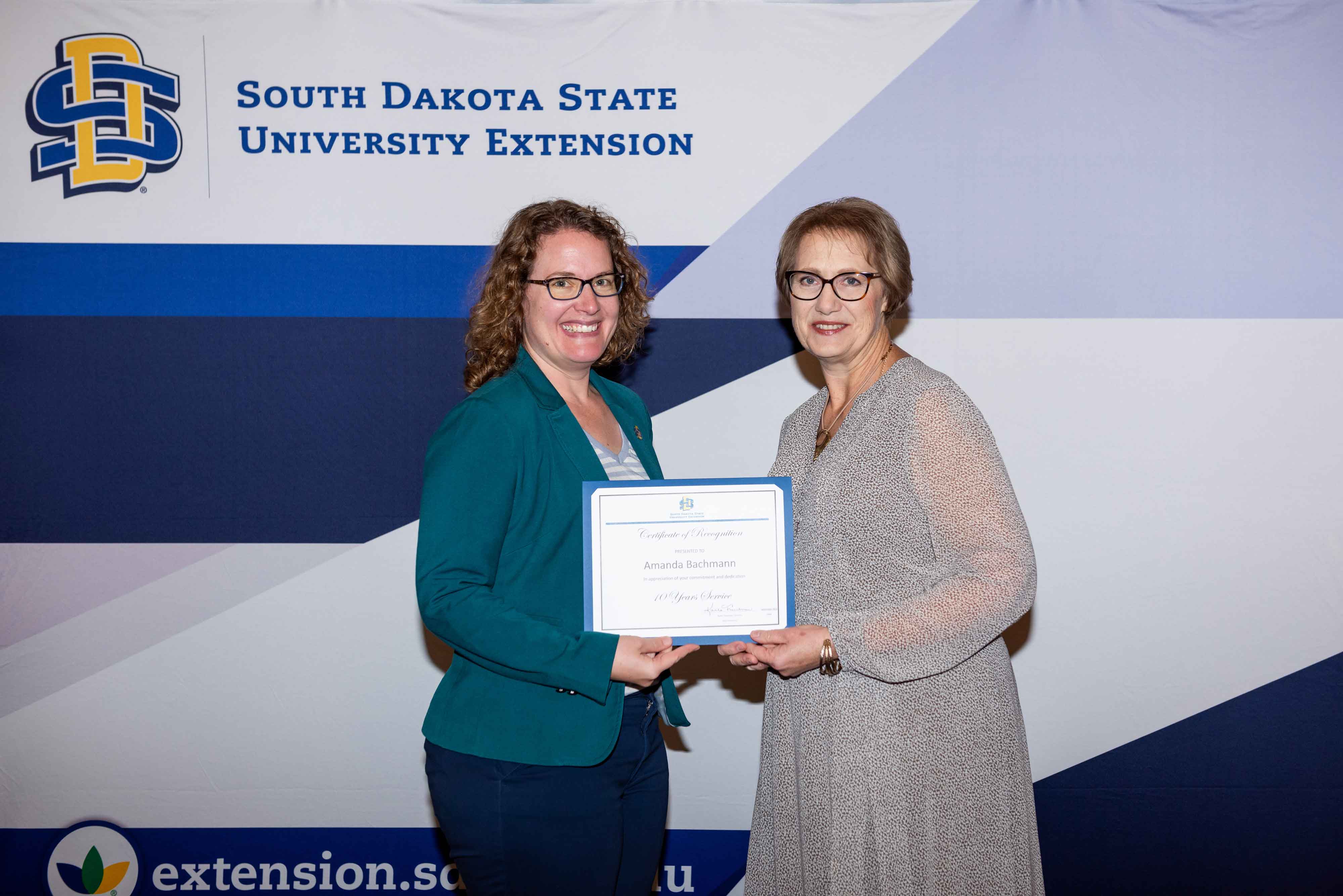 Amanda Bachmann receives a certificate for 10 years of service from Karla Trautman