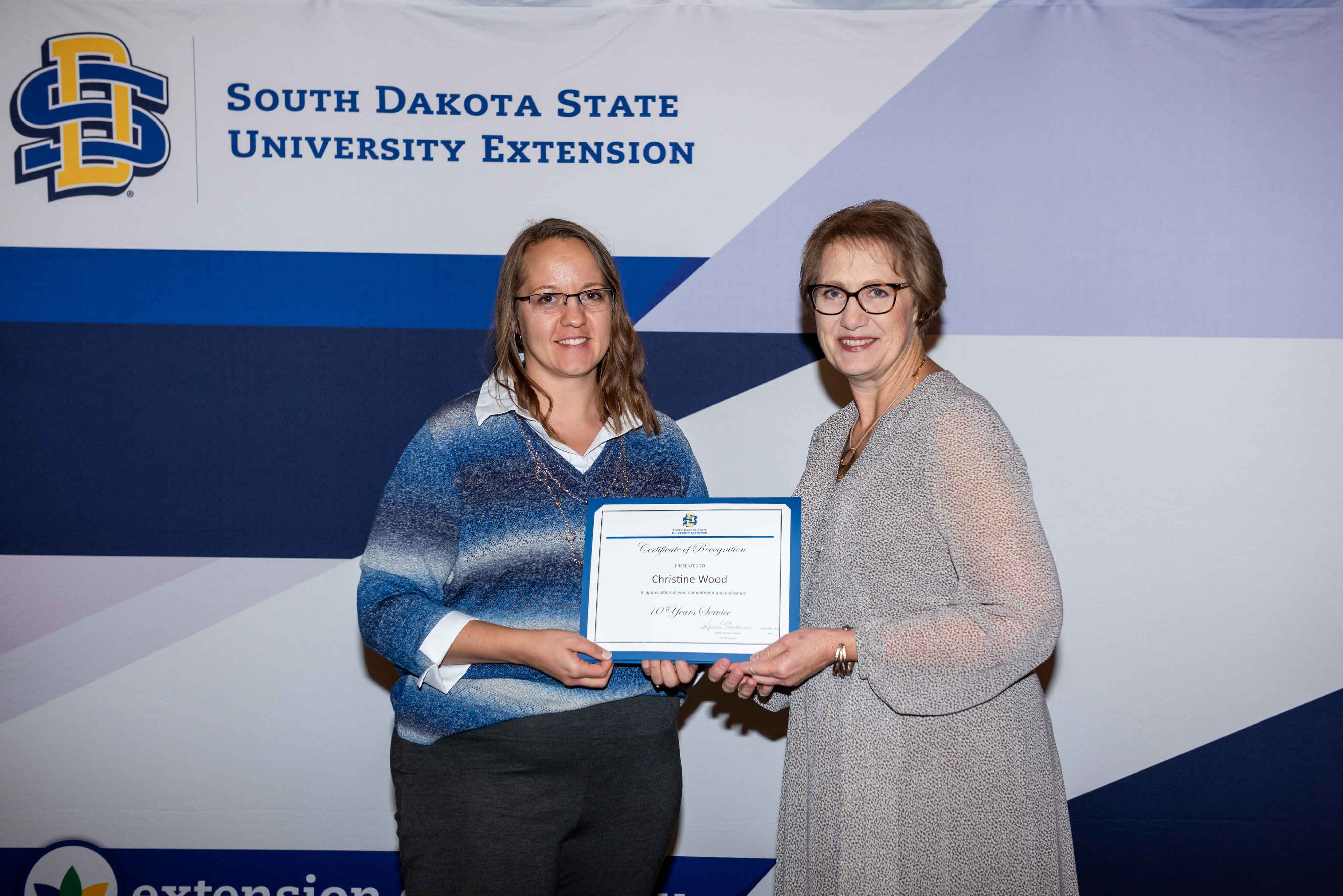 Christine Wood receives a certificate from Karla Trautman