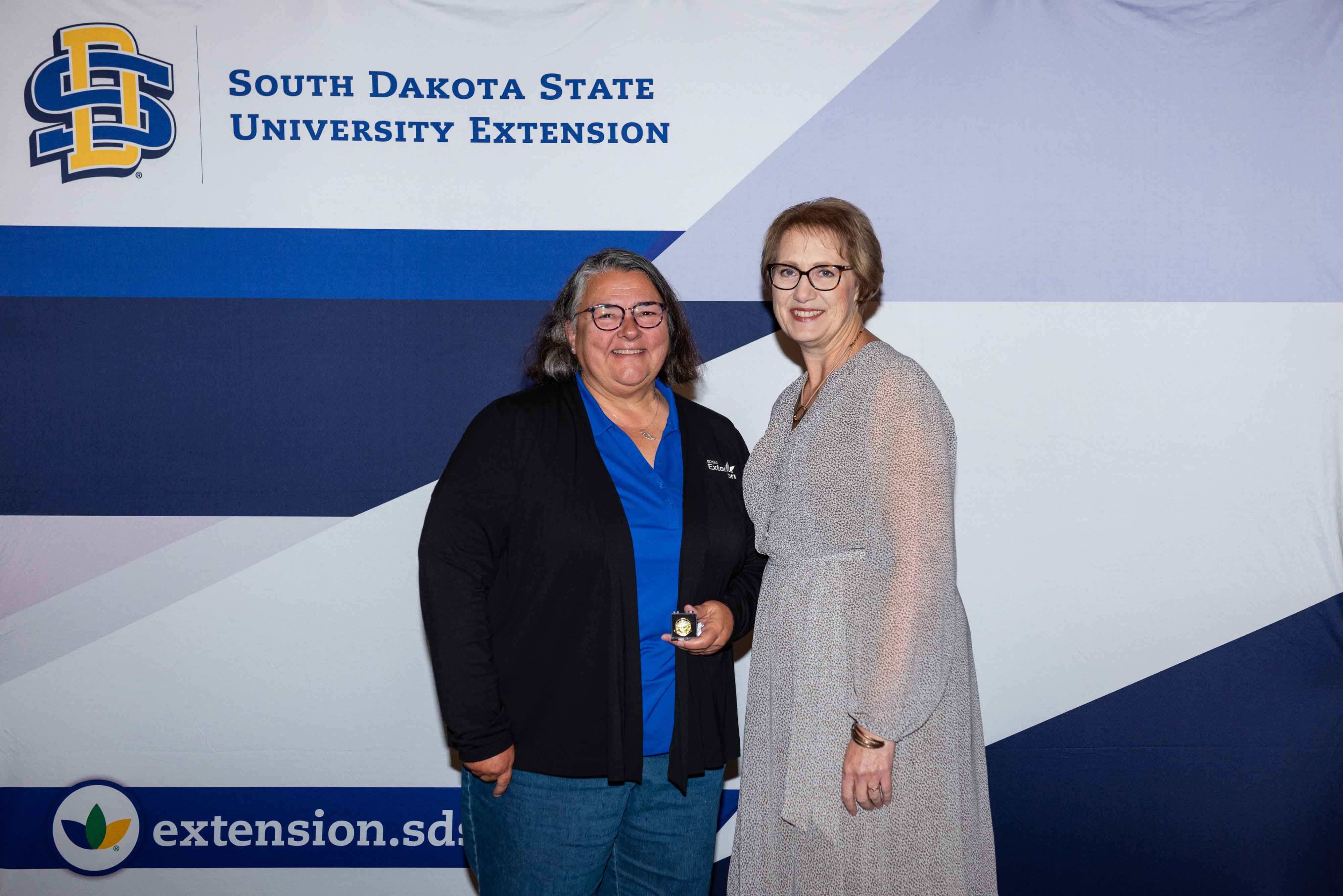 Debra Lessman receives her 10-year pin from Karla Trautman