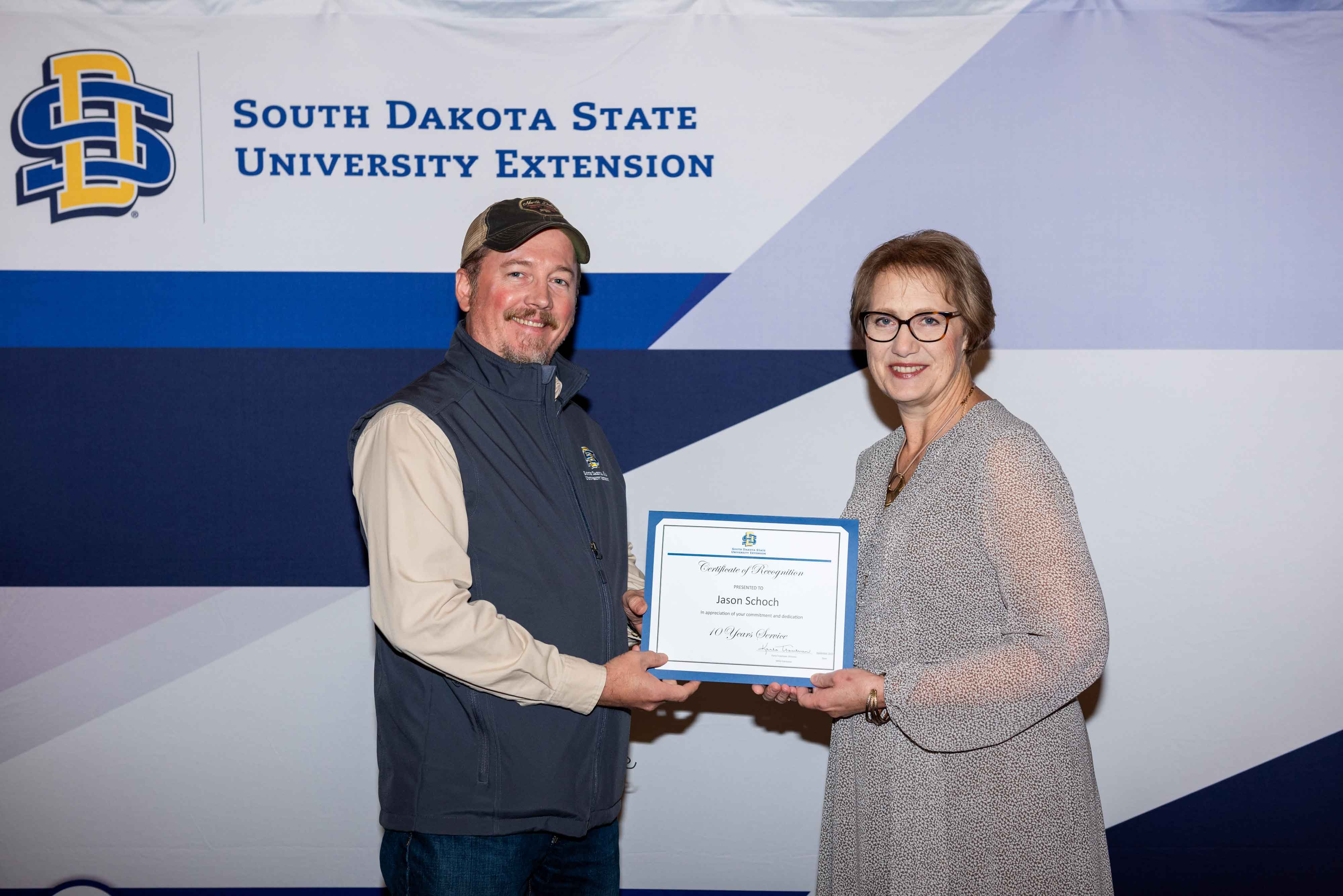 Jason Schoch receives a certificate for 10 years from Karla Trautman
