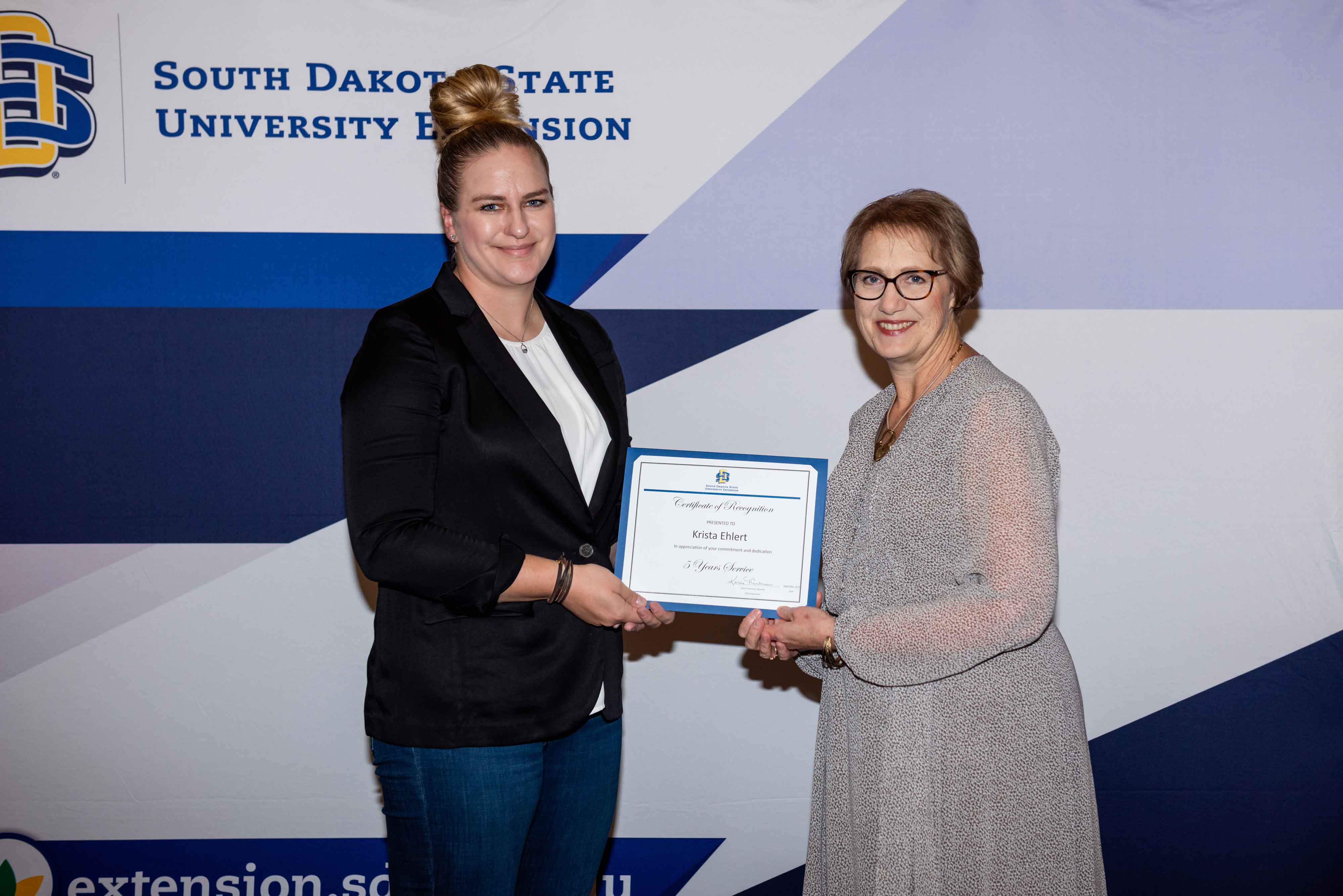 Krista Ehlert receives a certificate for 5 years of service from Karla Trautman