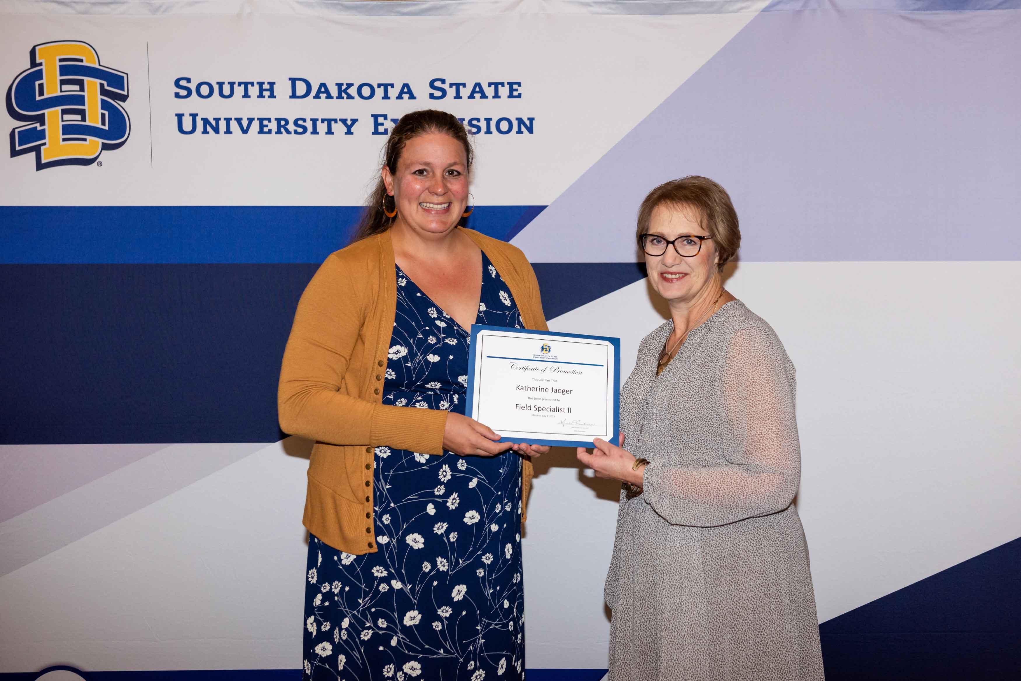 Katherine Jaeger accepts a certificate from Karla Trautman