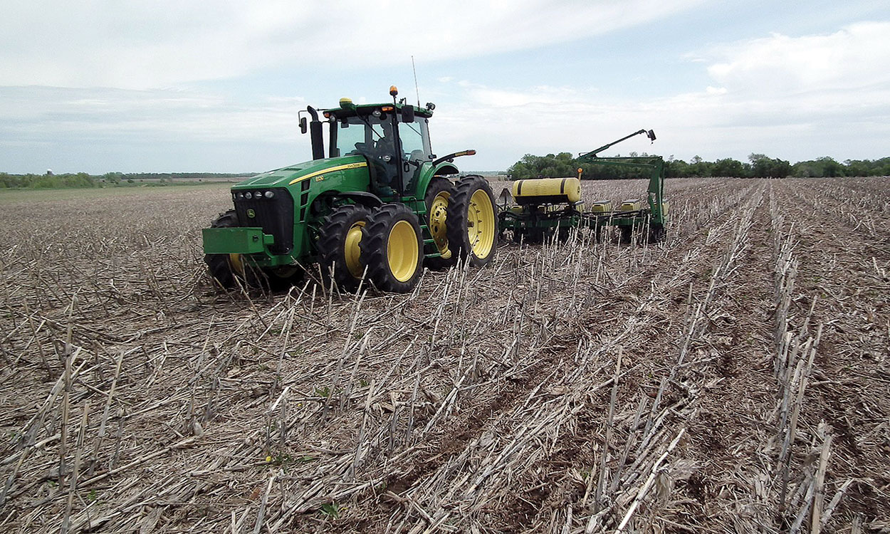 Tractor planting seed in a no-till field.