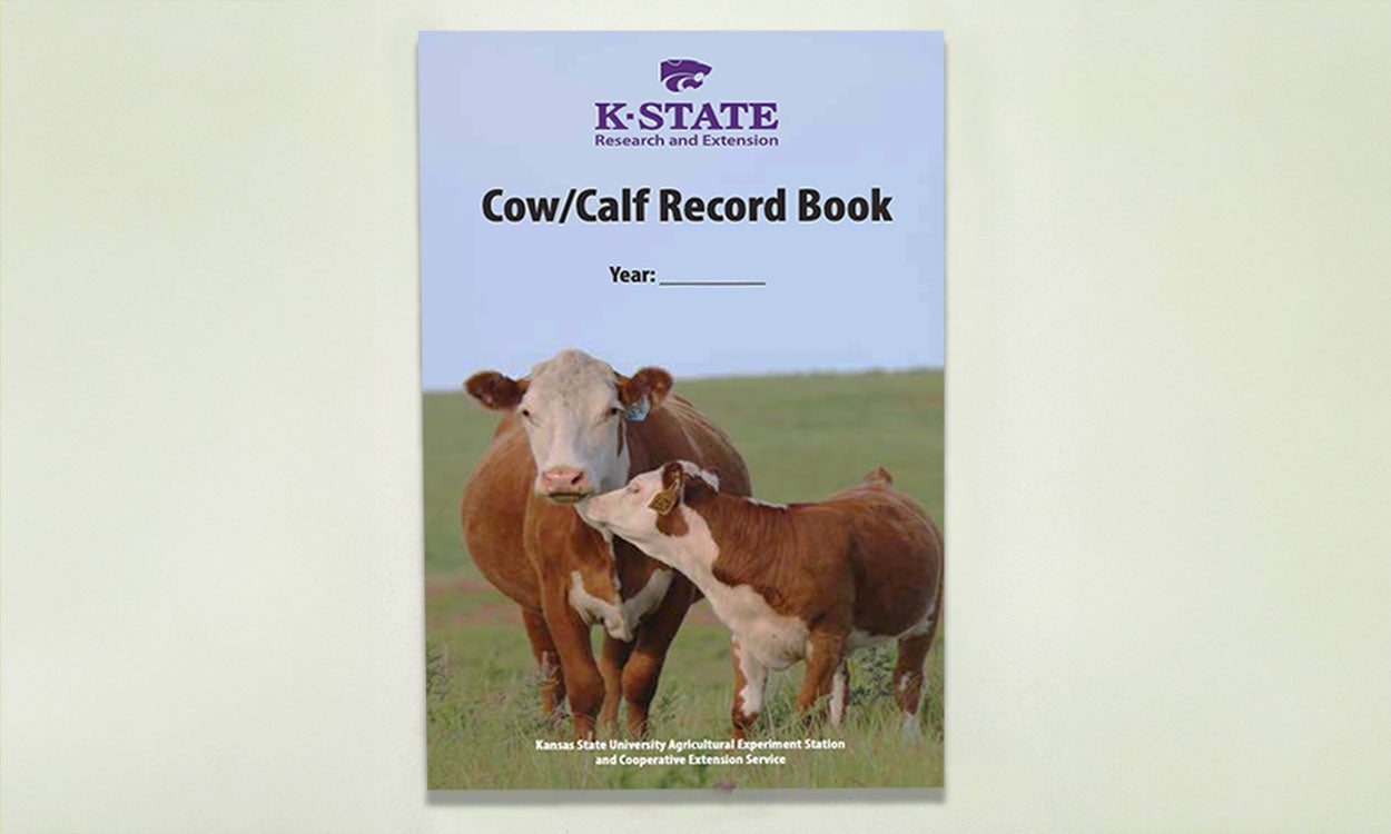 Kansas State University Extension Cow/Calf record book. On the cover of the book is a Hereford cow and calf.