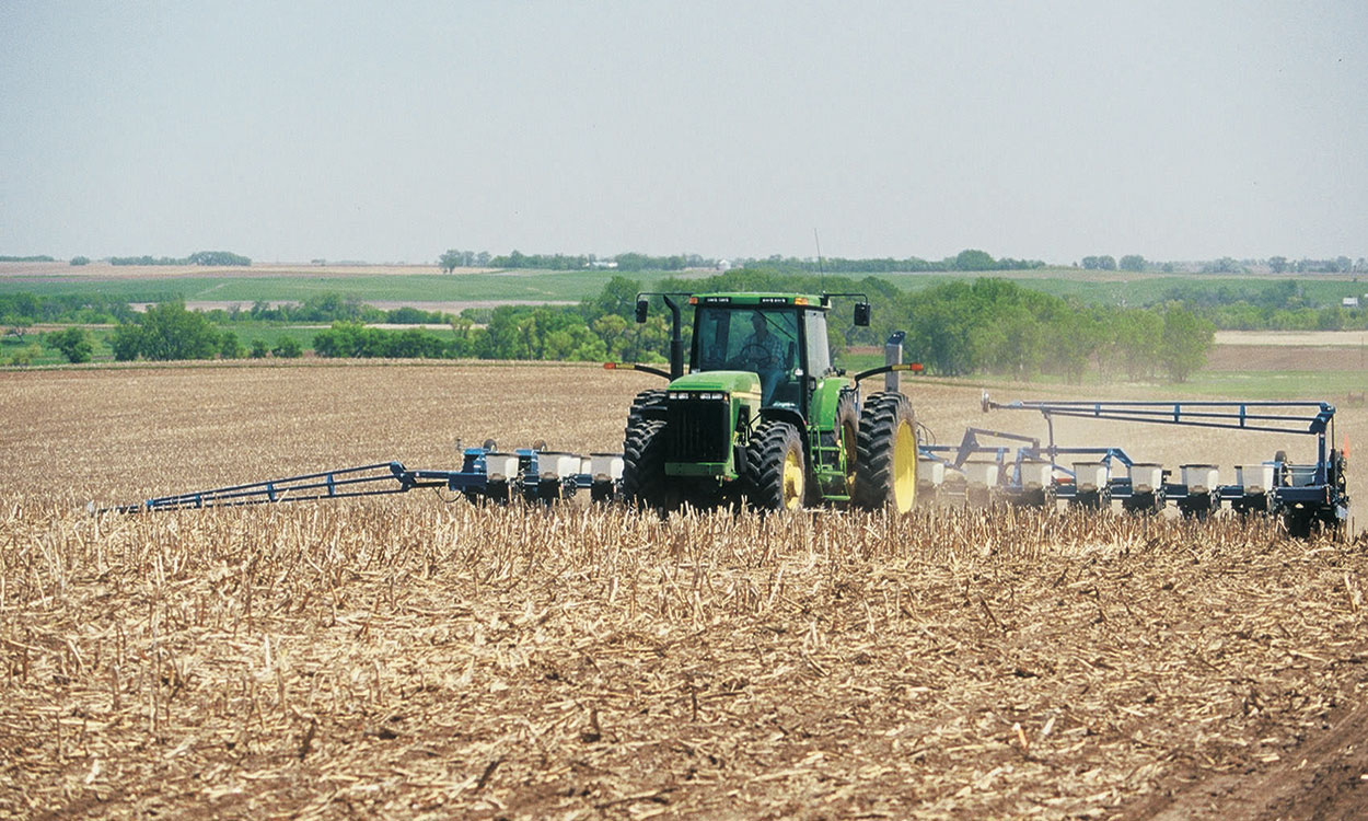 Tractor planting seed in a no-till field.