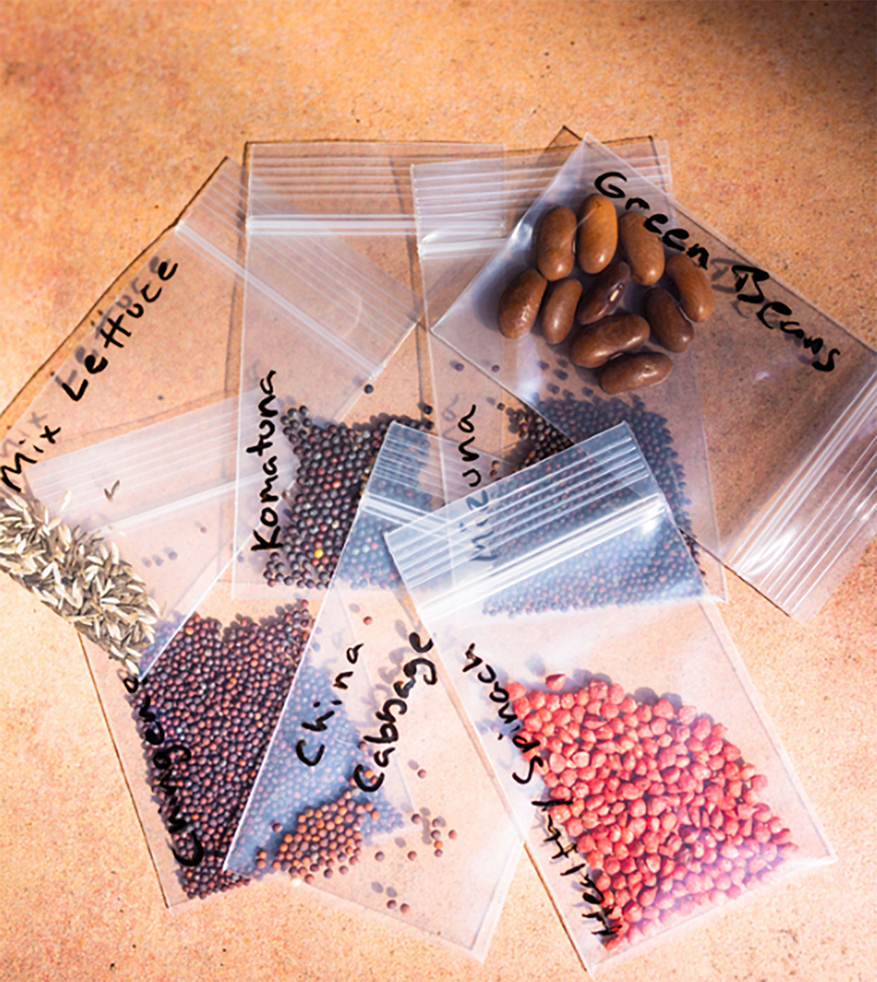 Plastic bags filled with various vegetables seeds.