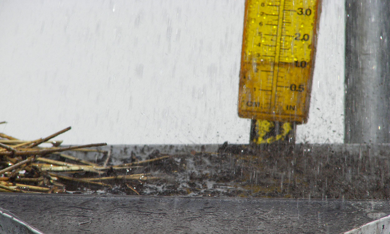 Rain falls on a sample of conventional tilled in a rainfall simulator.