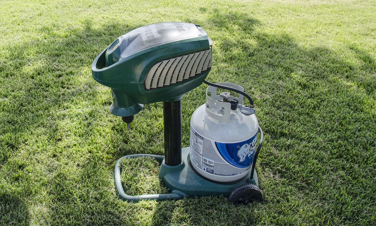 A carbon dioxide mosquito trap set up on a lawn.