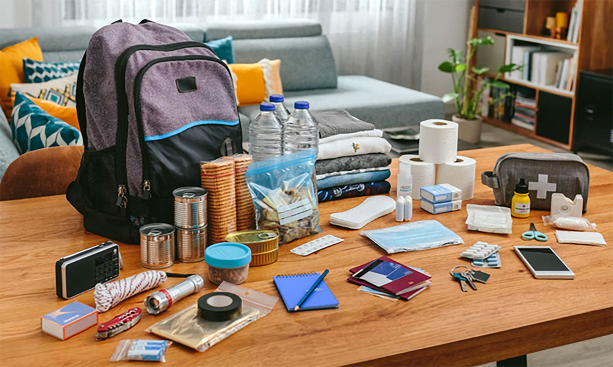 Backpack with emergency supplies on a living room table.