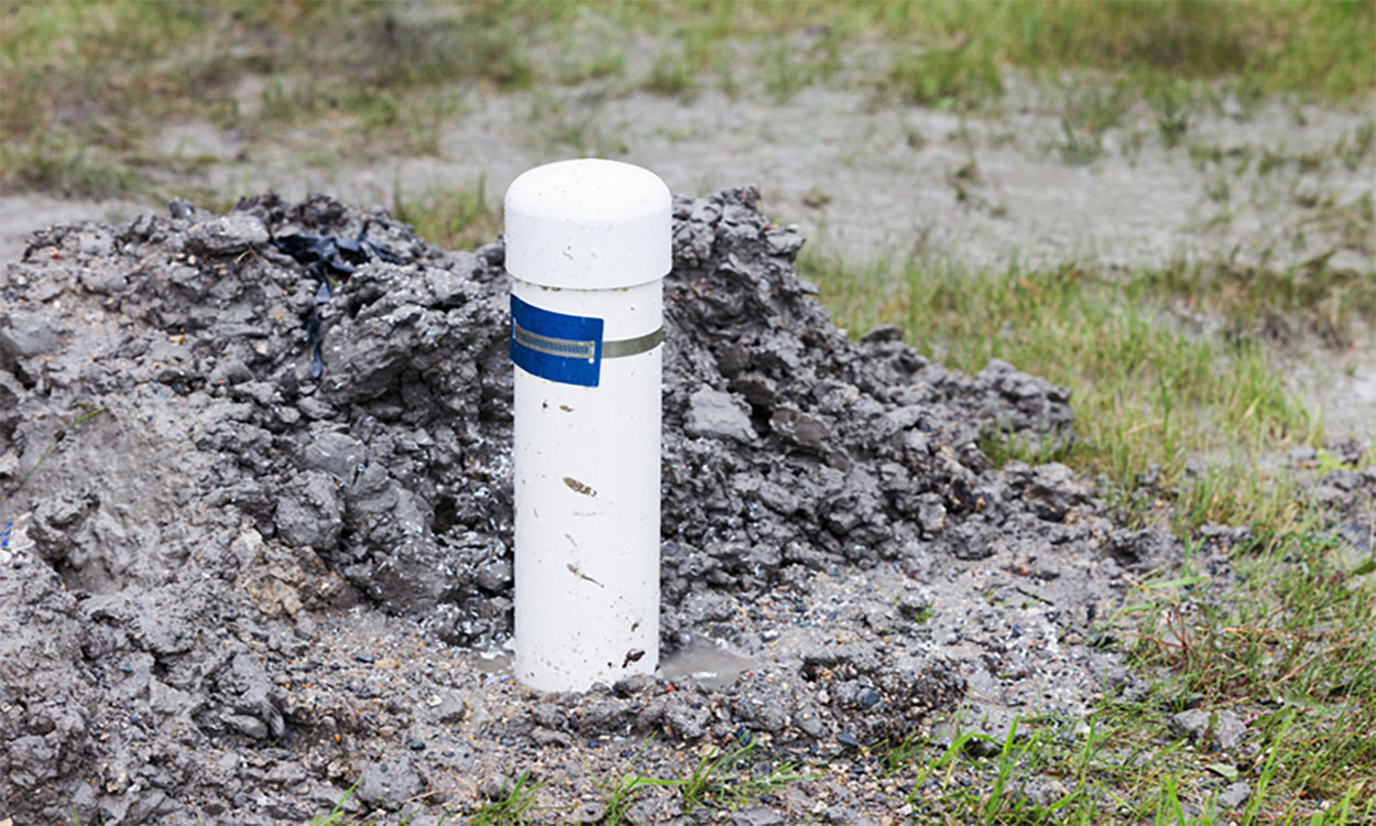 Residential water well in a flooded lawn.