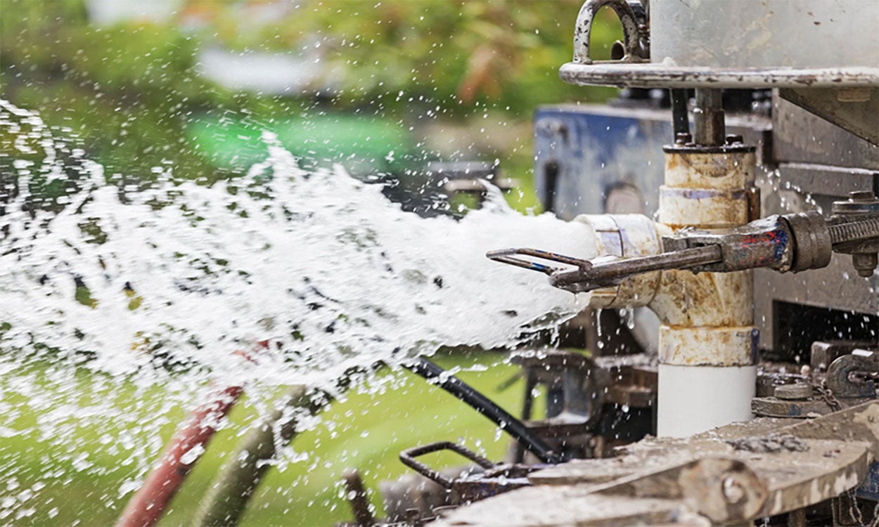 Machinery drilling a new residential water well.