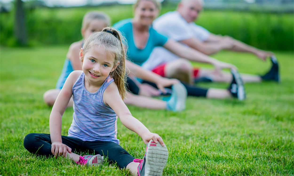 Family stretching in their backyard before beginning exercise.