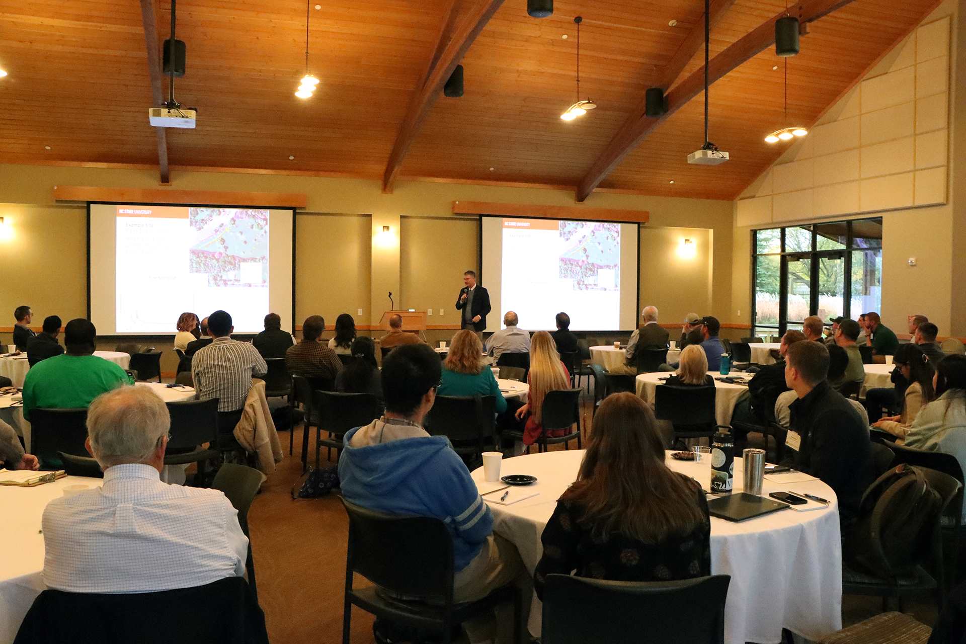 A group of people listening to a presentation