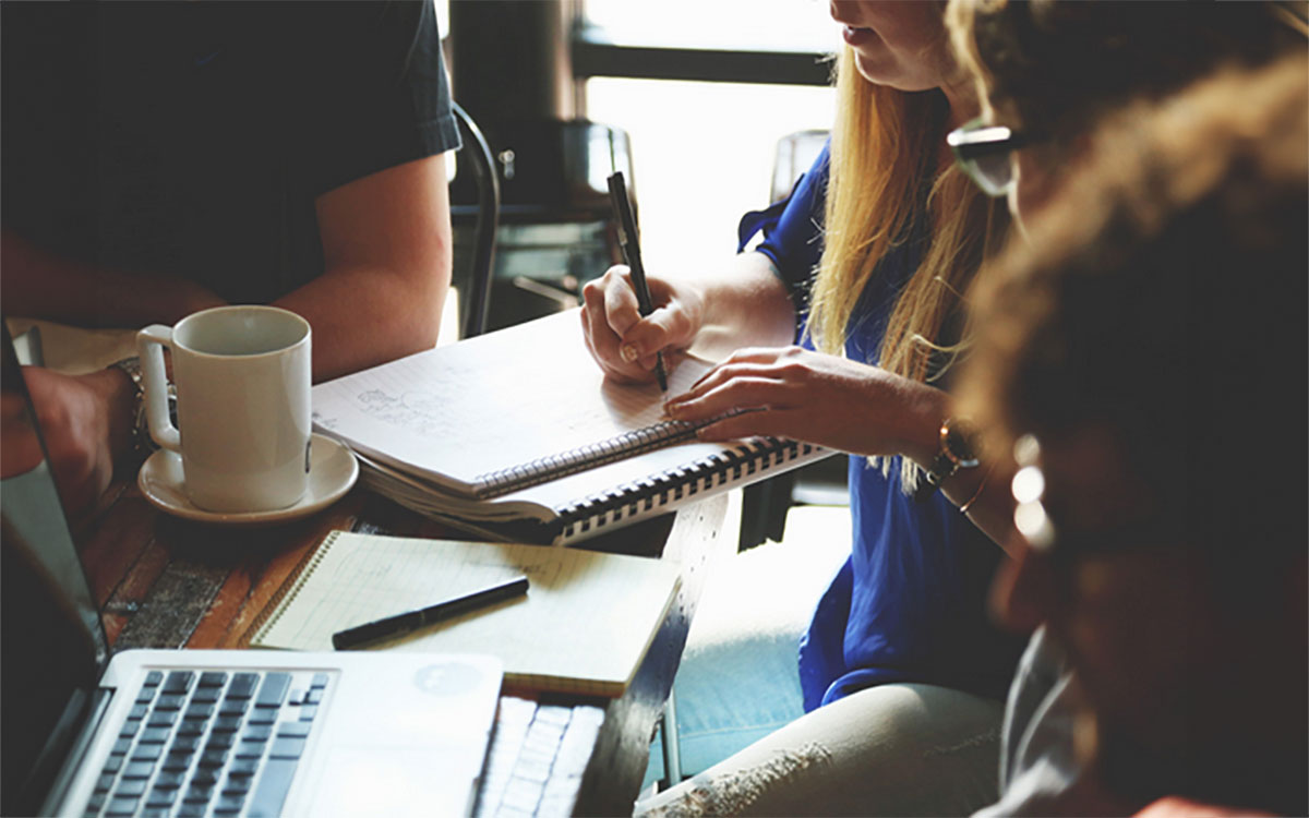 A group of writing workshop attendees gathered at a table.