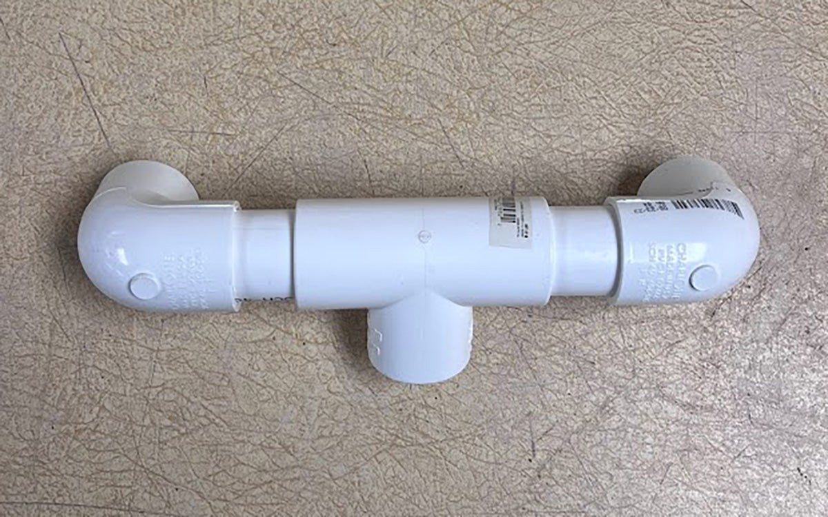 Two-inch pieces of PVC pipe fitted with elbow joints on their ends and a t-joint in the middle.