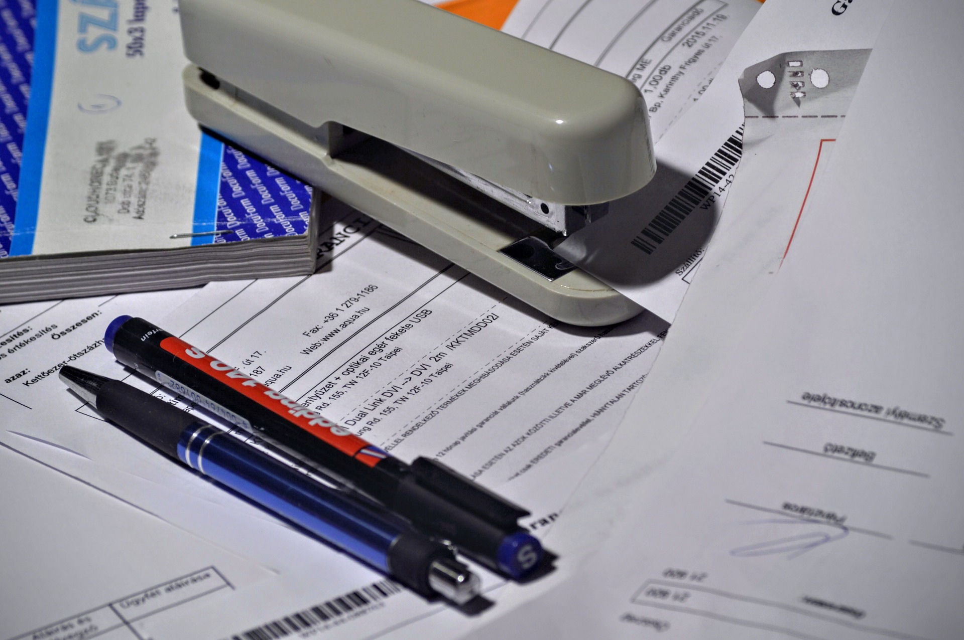 A stack of paperwork that needs to be organized.