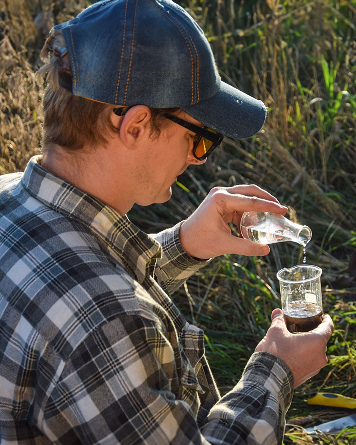 Soil scientist combining water with a soil sample in the field.