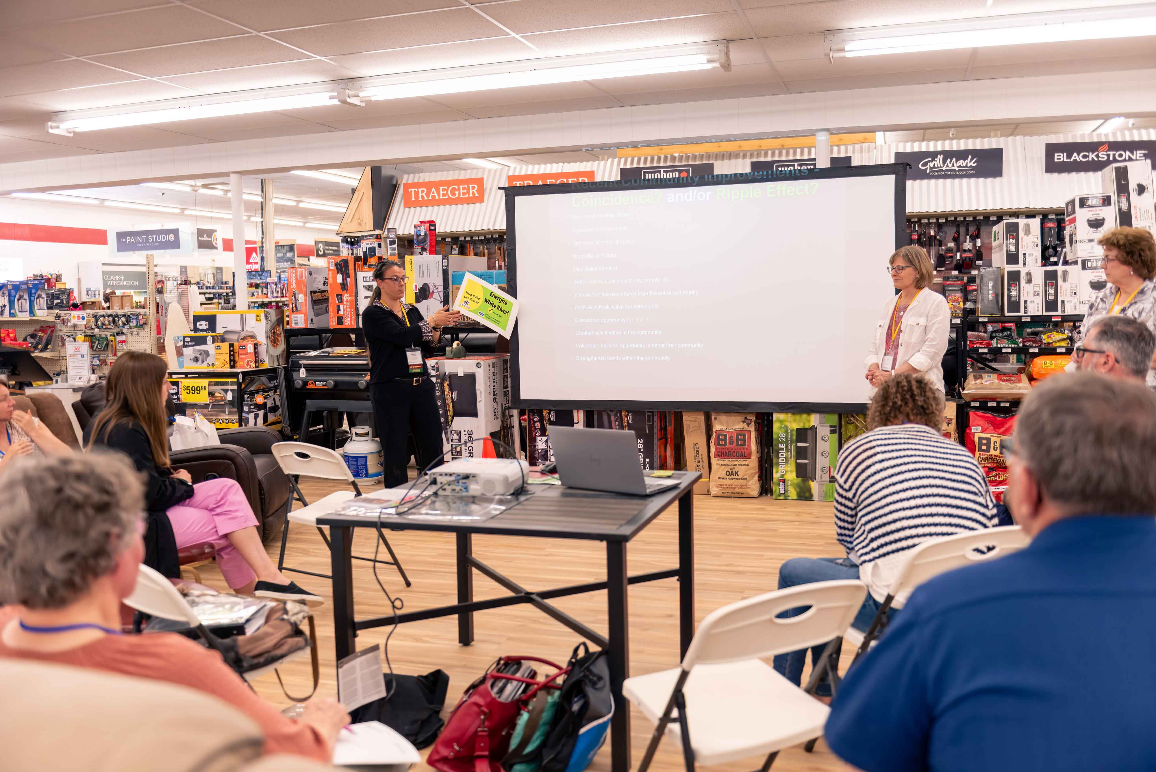 Two women give a presentation inside a store