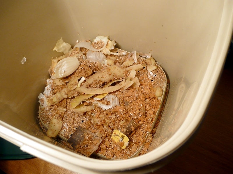 Tan plastic ban with food scraps