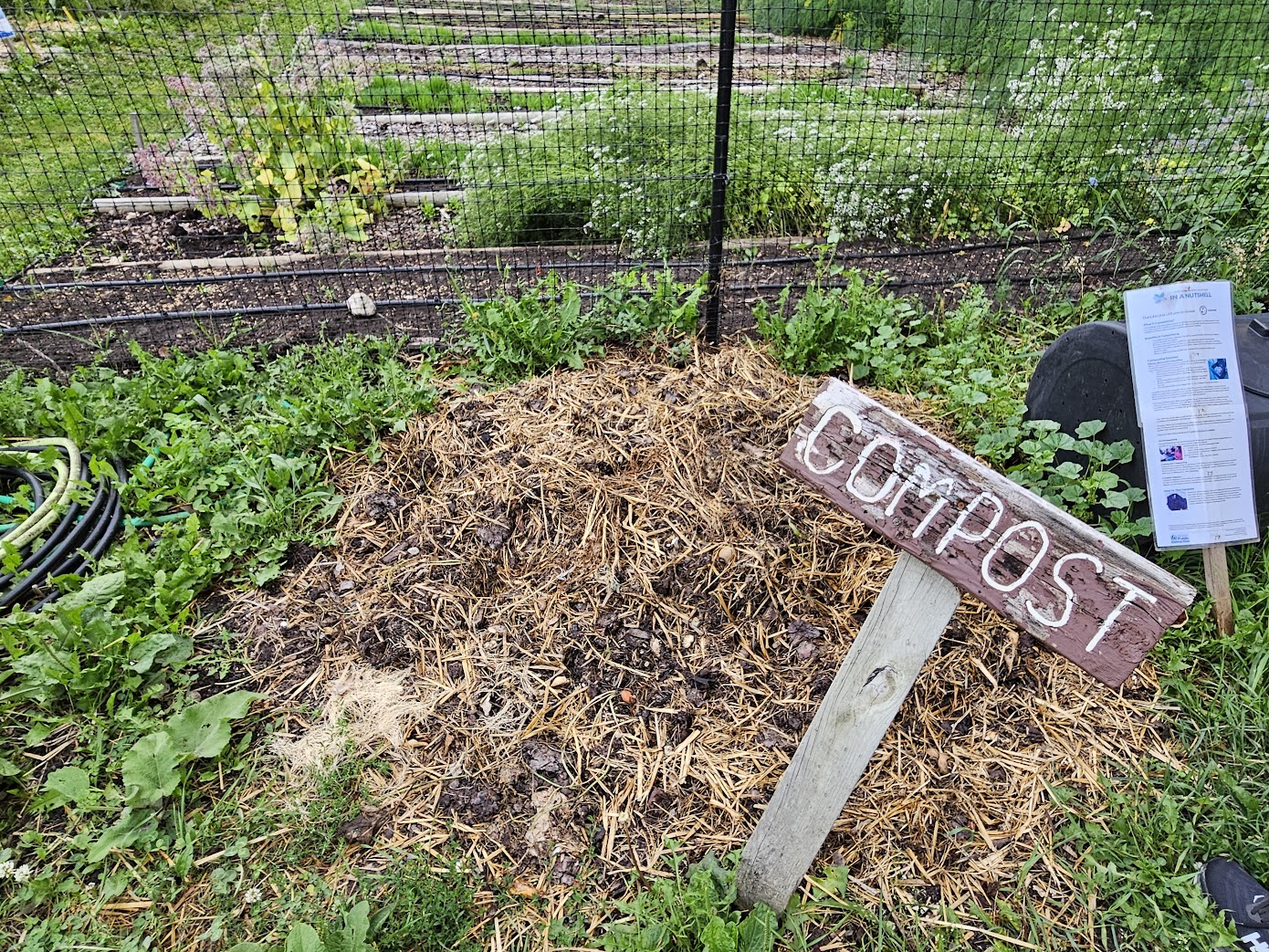 A pile of soil and compost covered with straw