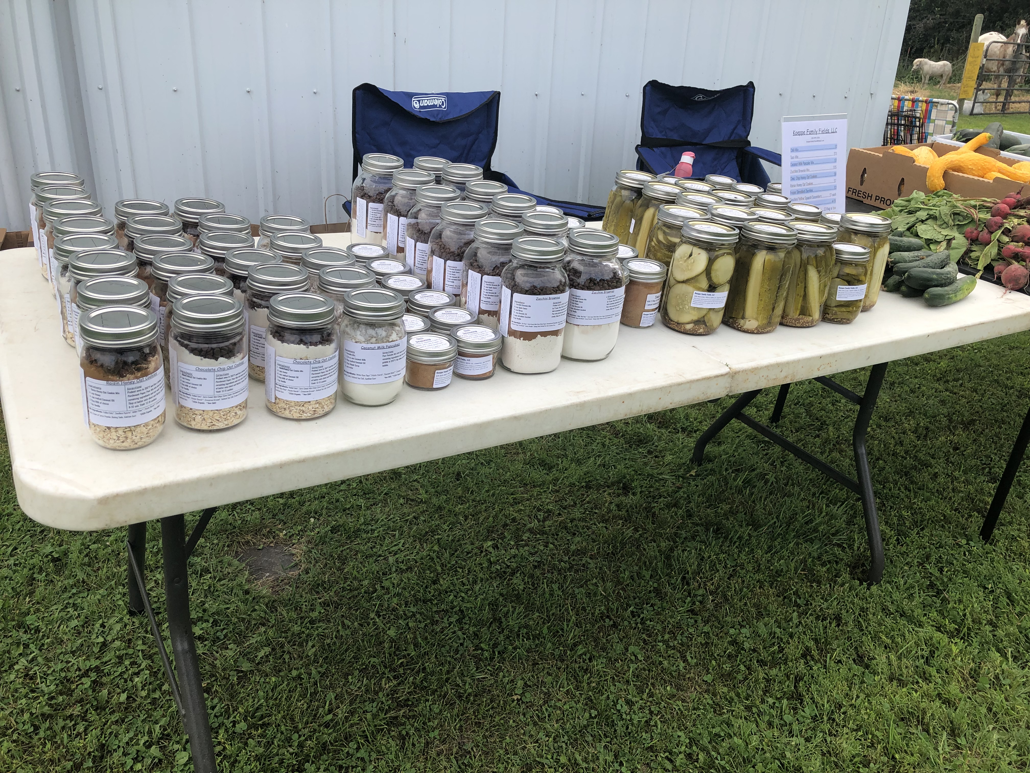 a table full of canned jars or vegetables and other canned good