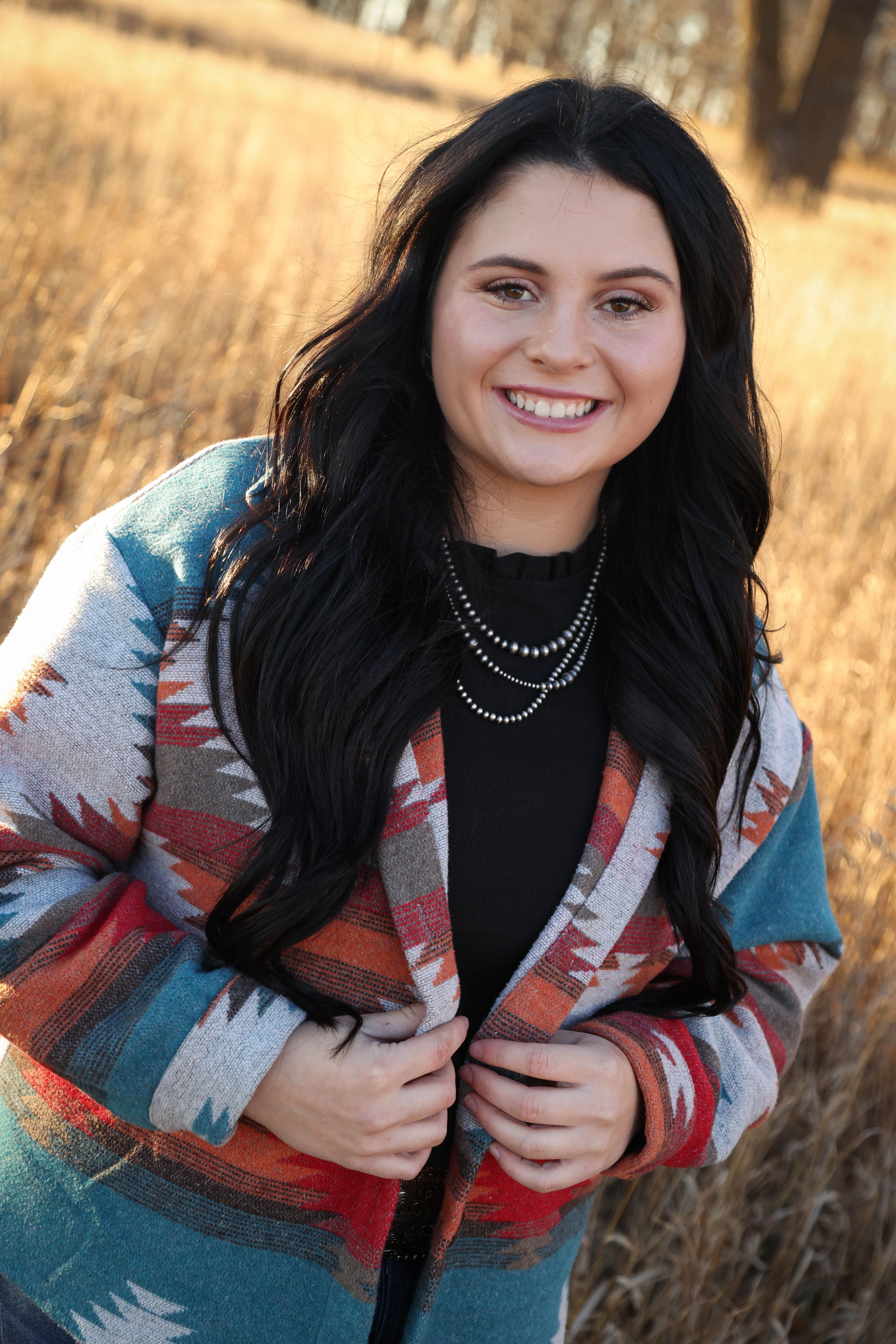 A woman smiles for a portrait