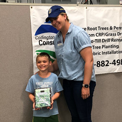 Harley Heber, Wessington Springs, and SDSU Extension Range Specialist Krista Ehlert display Heber's first place plaque in New Ranger rangeland display at the 2023 Rangeland and Soils Days held June 14-15 near Watertown.