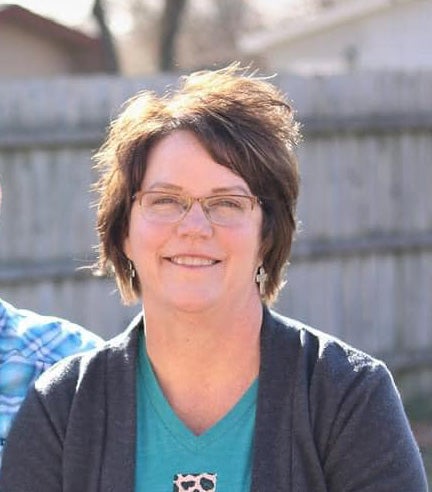 A woman smiles at the camera