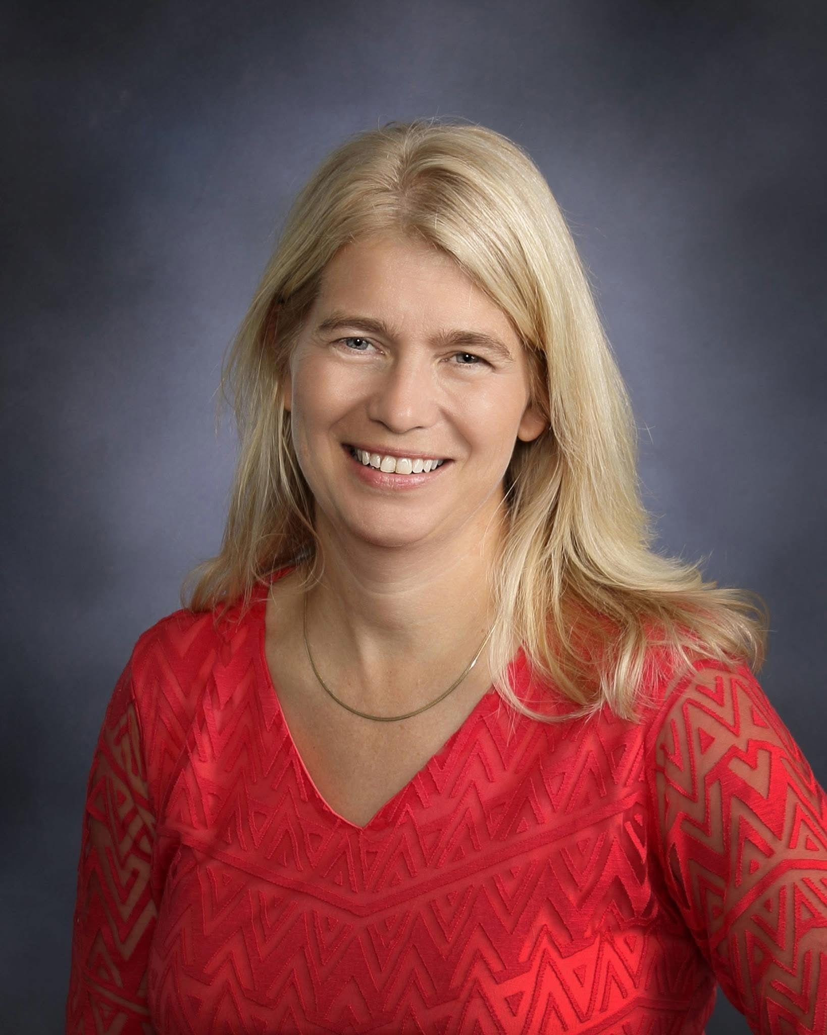 A woman smiles for a portrait