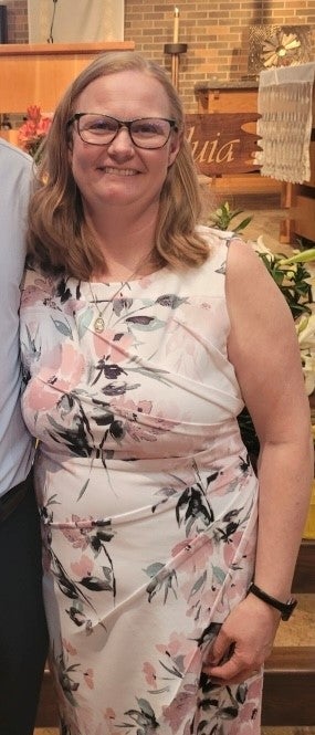 A woman smiles for a portrait