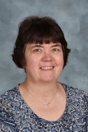 A woman smiles for a portrait