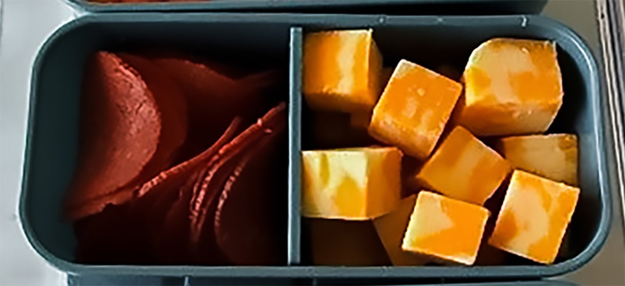 Snackle box cubes with pepperoni slices and cubed cheese.