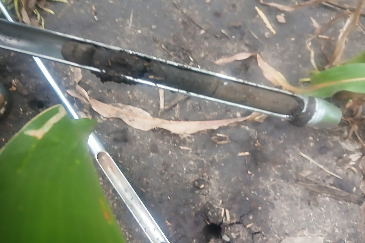Soil probe analyzing a core of soil in a bare, conventionally tilled field.
