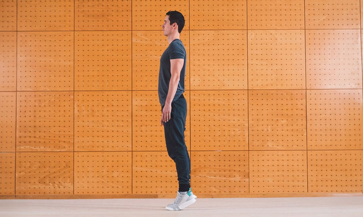 Man doing calf raise exercise in a gym.