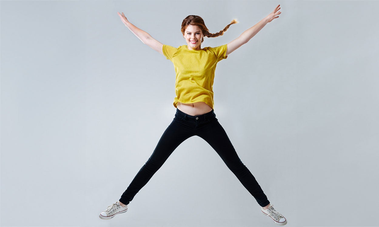 Woman demonstrating the star jump exercise.