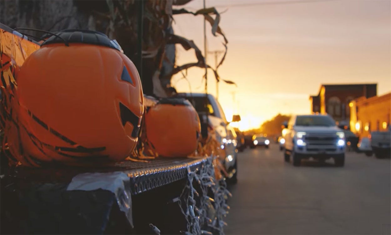 A Pumpkin Fest parade float on main street Webster featuring jack-o’-lanterns, lights, and dried corn.
