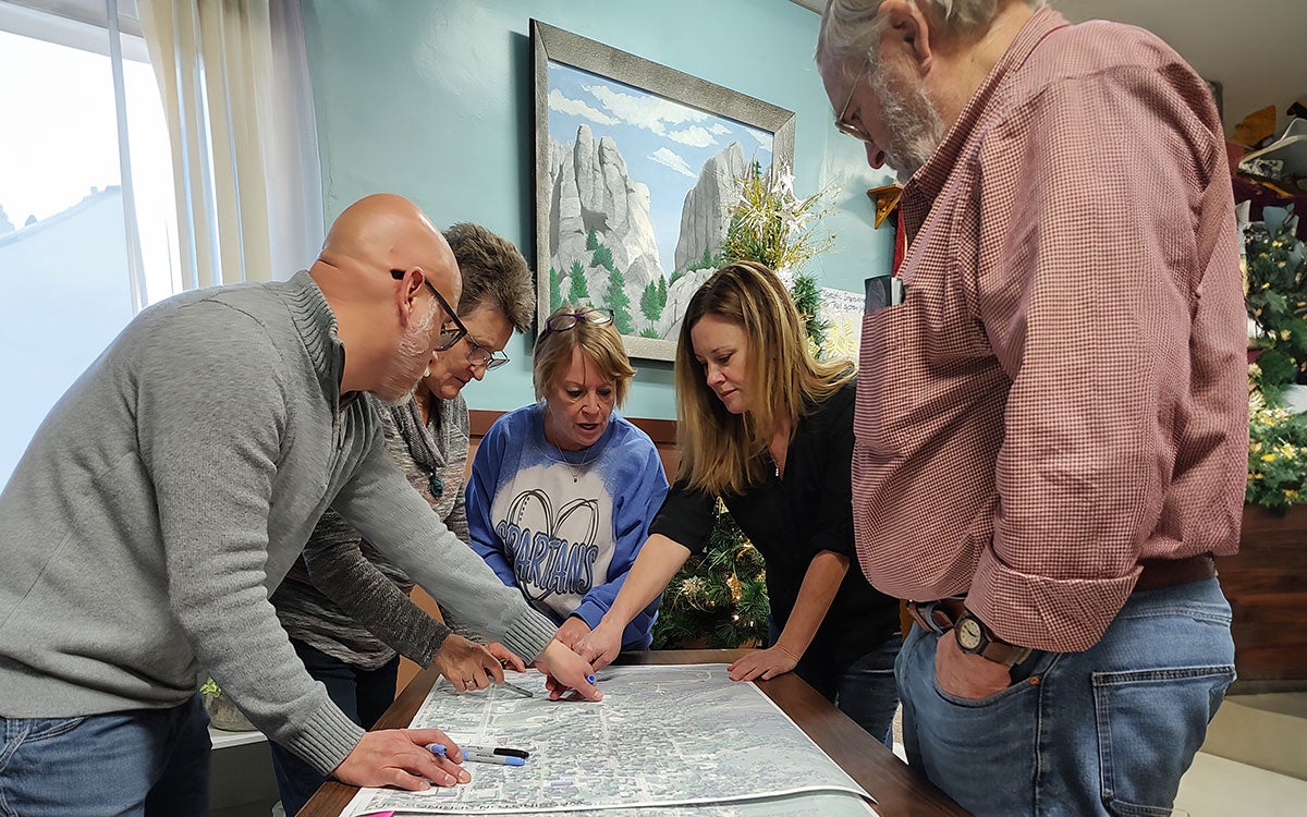 Wessington Springs Healthy Landscapes, Healthy Communities Initiative team gathered around a conference table.