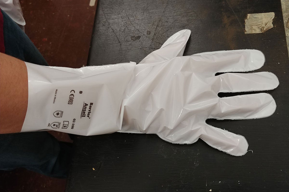 A white glove with black lettering.