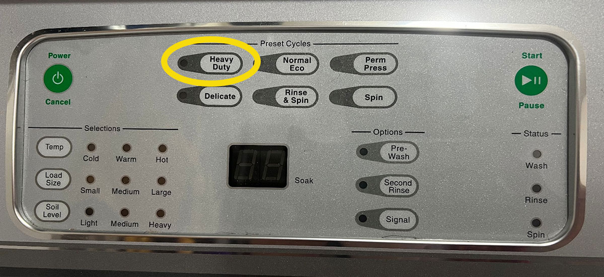 Washing machine console with a yellow circle around the heavy-duty cycle option.