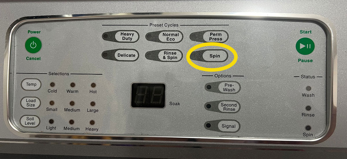 Washing machine console with a yellow circle around spin cycle.