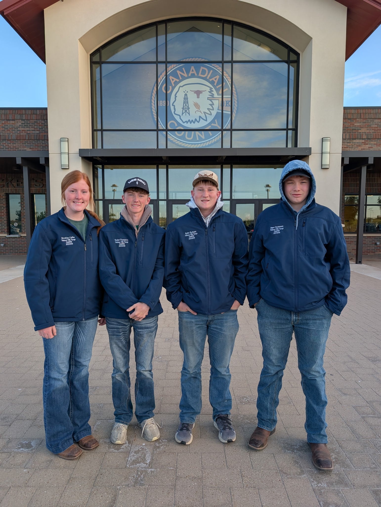 Four youth smile for the camera