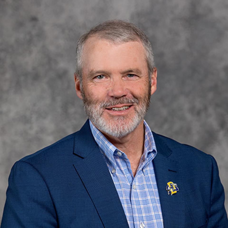 Professional headshot of Russ Daly