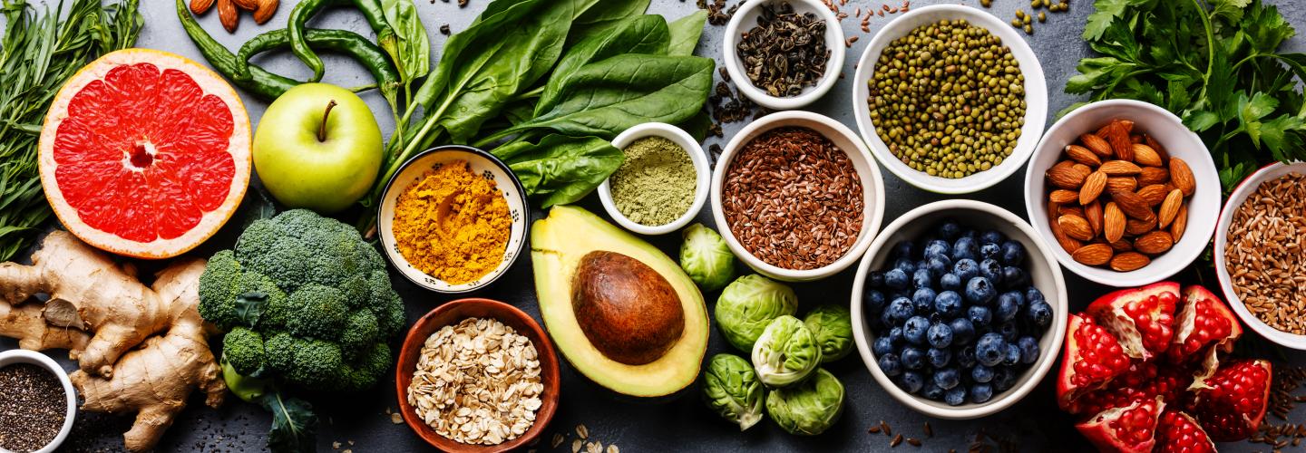 a variety of bright colored fruits and vegetables arranged on a table