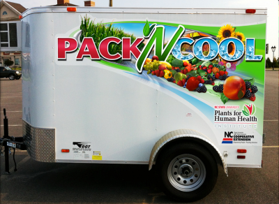 A medium-sized cooler trailer with "Pack N Cool" lettering on the side