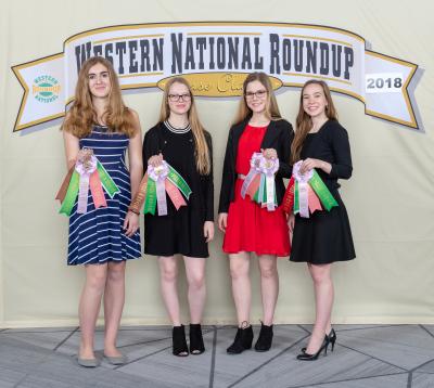 four women holding their award ribbons