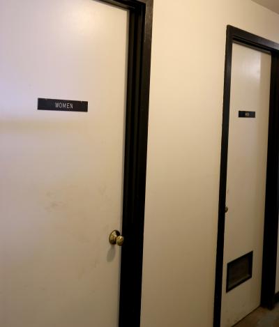 two restroom doors side by side. left is women's room. right is men's.