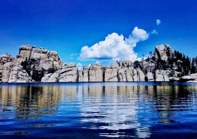 granite rock formation surrounding a lake.